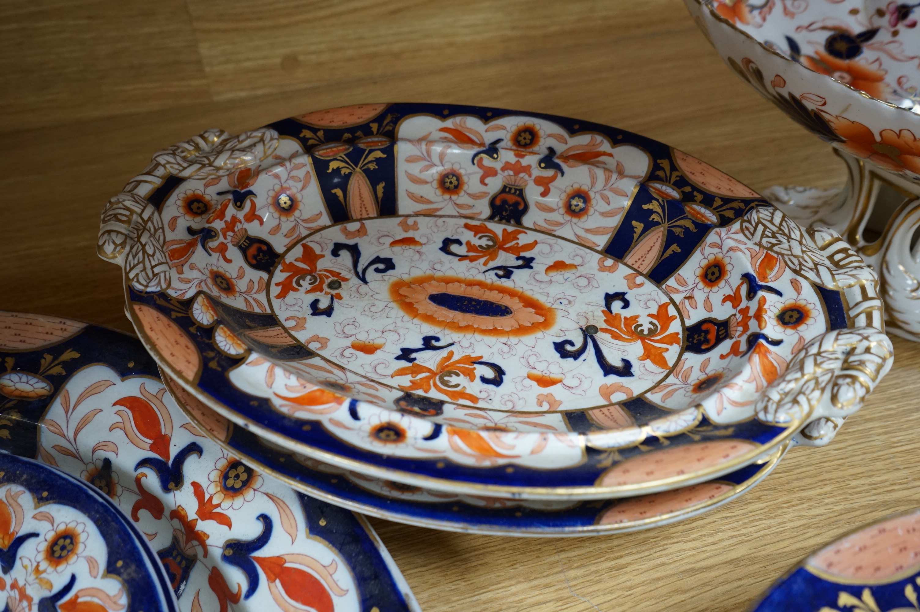 Fifteen items of a mid 19th century Mason's/Ashworth’s ironstone dinner service. Oval meat platter 48.5cm wide. Condition - three plates chipped, some losses to gilding